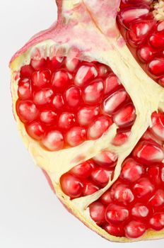 Half of pomegranate closeup on a white background