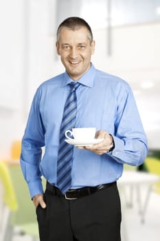 An image of a handsome business man with a cup of coffee