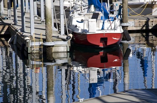 Reflections of boats, water, pier, dock, Edmond Washington  Trademarks removed.