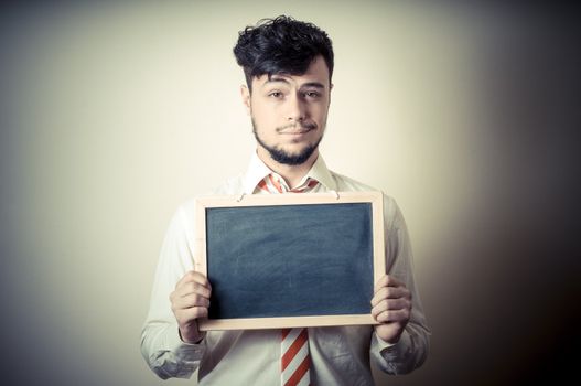 businessman with a blank blackboard on gray background