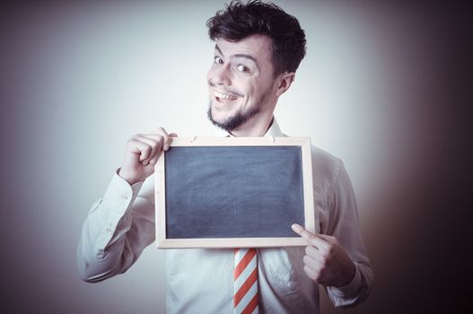 businessman with a blank blackboard on gray background