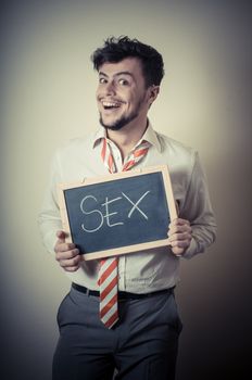 businessman with a blank blackboard write sex on gray background