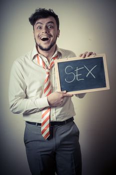 businessman with a blank blackboard write sex on gray background