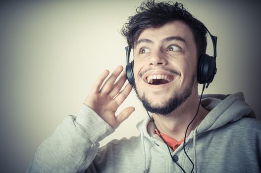 boy with sweatshirt and headphones on gray background 