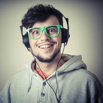 boy with sweatshirt and headphones on gray background 