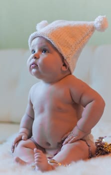 Portrait of baby in hat looking left