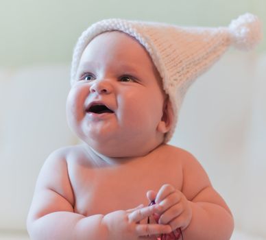 Portrait of smiling baby in white hat
