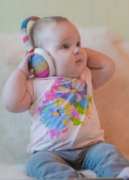 Portrait of baby in t-shirt with headphones