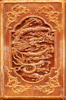 Dragon design on the wooden door of Chinese temple