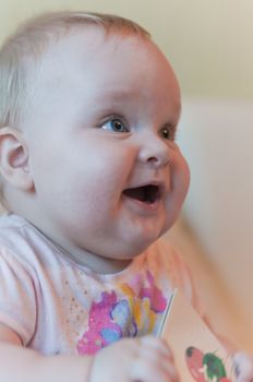 Portrait of the smiling baby looking right