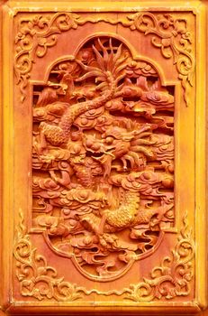 Dragon design on the wooden door of Chinese temple