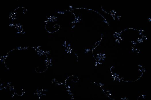 Elegant bright blue flowers on black fabric can use as background 