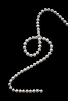 White pearls on the black velvet  background