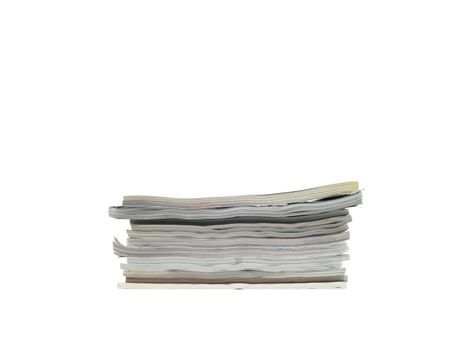 A stack of magazines isolated against a white background