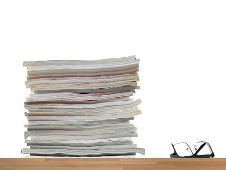 A stack of magazines isolated against a white background