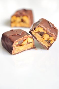 Chocolate covered bar with caramel and hazelnut