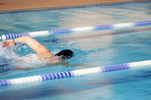 man swims in swimming pool