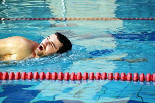 man swims in swimming pool