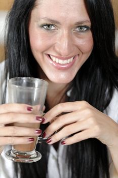 Attractive young woman taking a coffee break in her kitchen