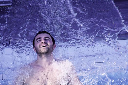 young attractive man relax in spa area