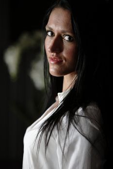 Portrait of a beautiful young woman in her kitchen.