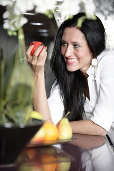 Attractive young woman eating an apple.