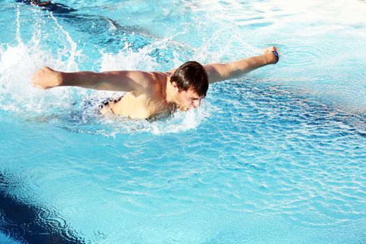 man swims in swimming pool