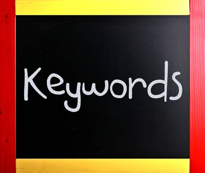 The word "Keywords" handwritten with white chalk on a blackboard