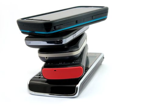 Pile of Several Modern Mobile Phones PDA Cell Handheld Units Isolated on White Background