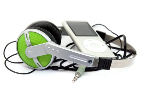 green headphones and mp3 player on white background