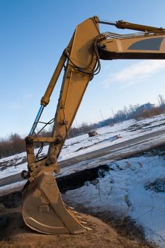 Steel bucket of an earth excavator standing idle