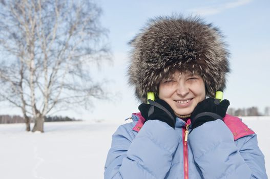 Woman tourist skier in snowy forest with ski