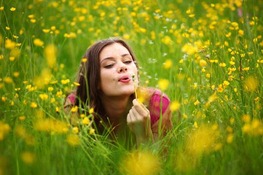 summer woman blow on dandelion 