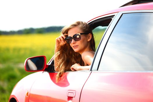 woman in red car get out window
