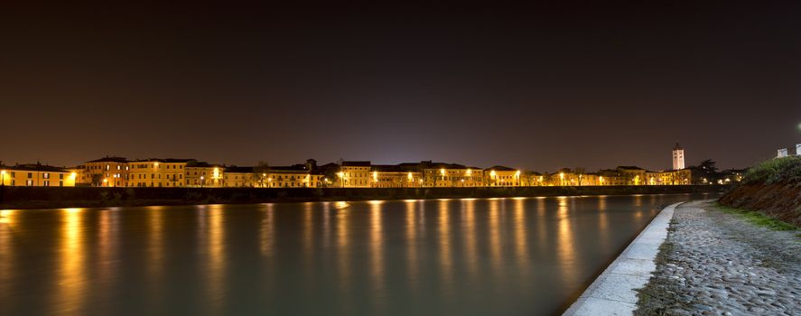 Night view of Adige River with the bell tower of St. Zeno in Verona Italy
