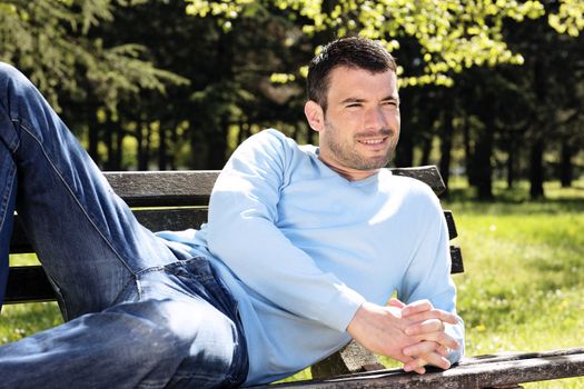 relaxed man on  a bench in spring