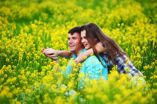 lovers hug on yellow flower field