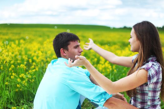 lovers hug on yellow flower field