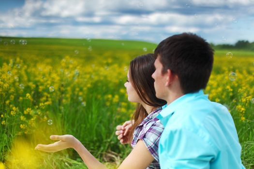 lovers hug on yellow flower field