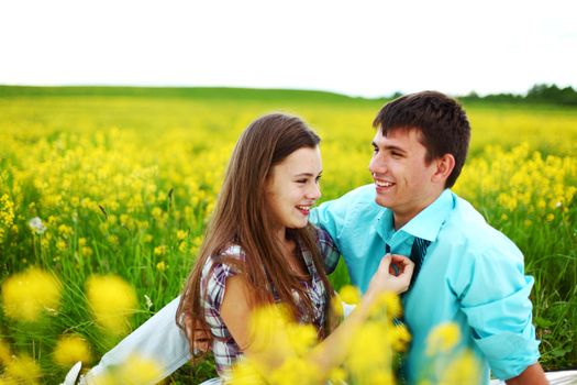 lovers hug on yellow flower field