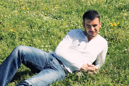 handsome man on the grass in a park