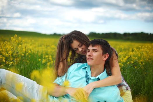 lovers hug on yellow flower field