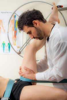 Manual, physio and kinesio therapy techniques performed by a male physiotherapist on a training plastic spine and a female patient