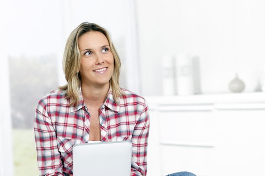 woman at home with tablet looking at someone