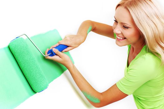 woman paints the wall brush