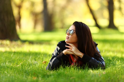 woman lay on green grass in park