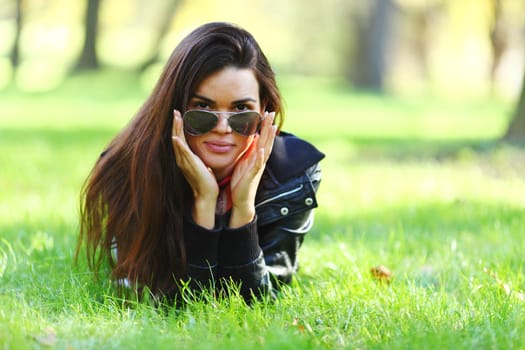 woman lay on green grass in park