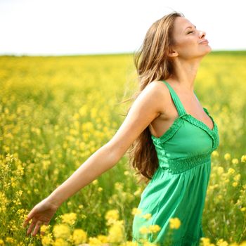 woman on oilseed field close portrait