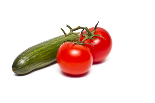 tomato and green cucumber isolated on a white background