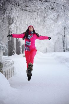 woman run in winter park very happy